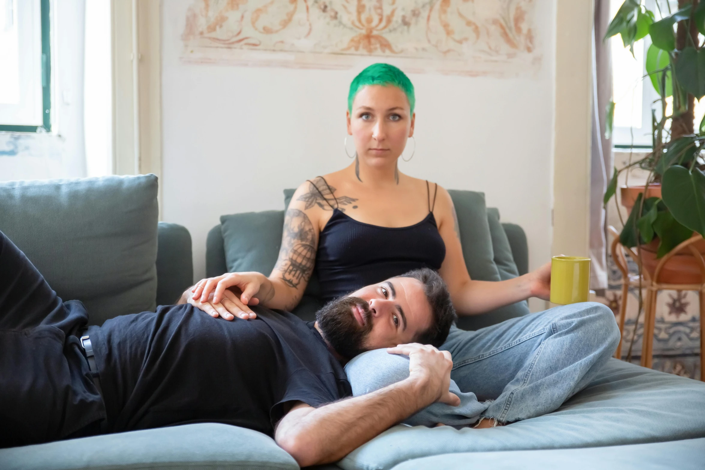 a man and a woman laying on a couch, a portrait, inspired by Elsa Bleda, pexels contest winner, renaissance, short green hair, tattoo artist, avatar image, intertwined full body view