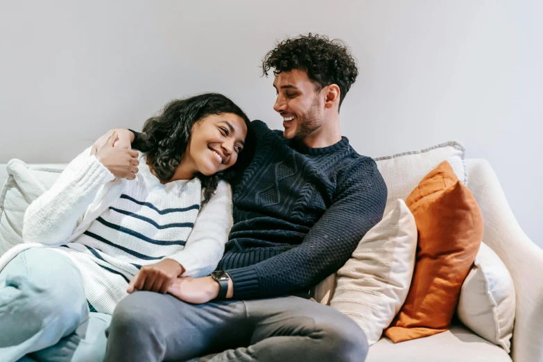 a man and a woman sitting on a couch, pexels contest winner, sweet hugs, flirting smiling, 1 4 9 3, instagram post