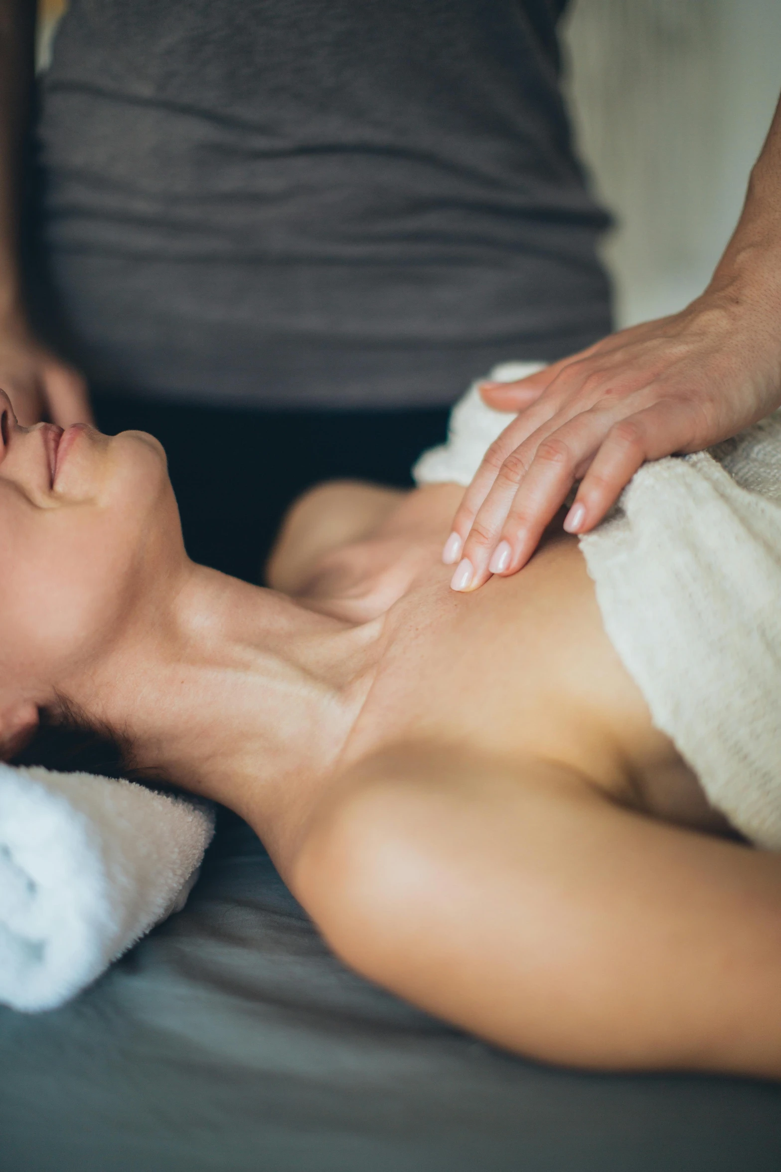 a woman getting a massage at a spa, a portrait, by Julia Pishtar, chest and face, neckline, bells, medium close shot