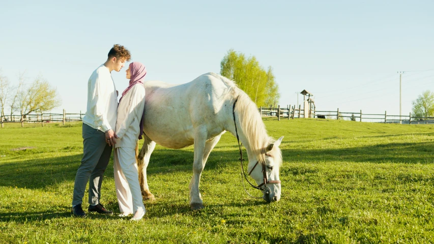 a woman standing next to a white horse in a field, inspired by Sir Alfred Munnings, unsplash, renaissance, man and woman walking together, islamic, on a green lawn, 15081959 21121991 01012000 4k