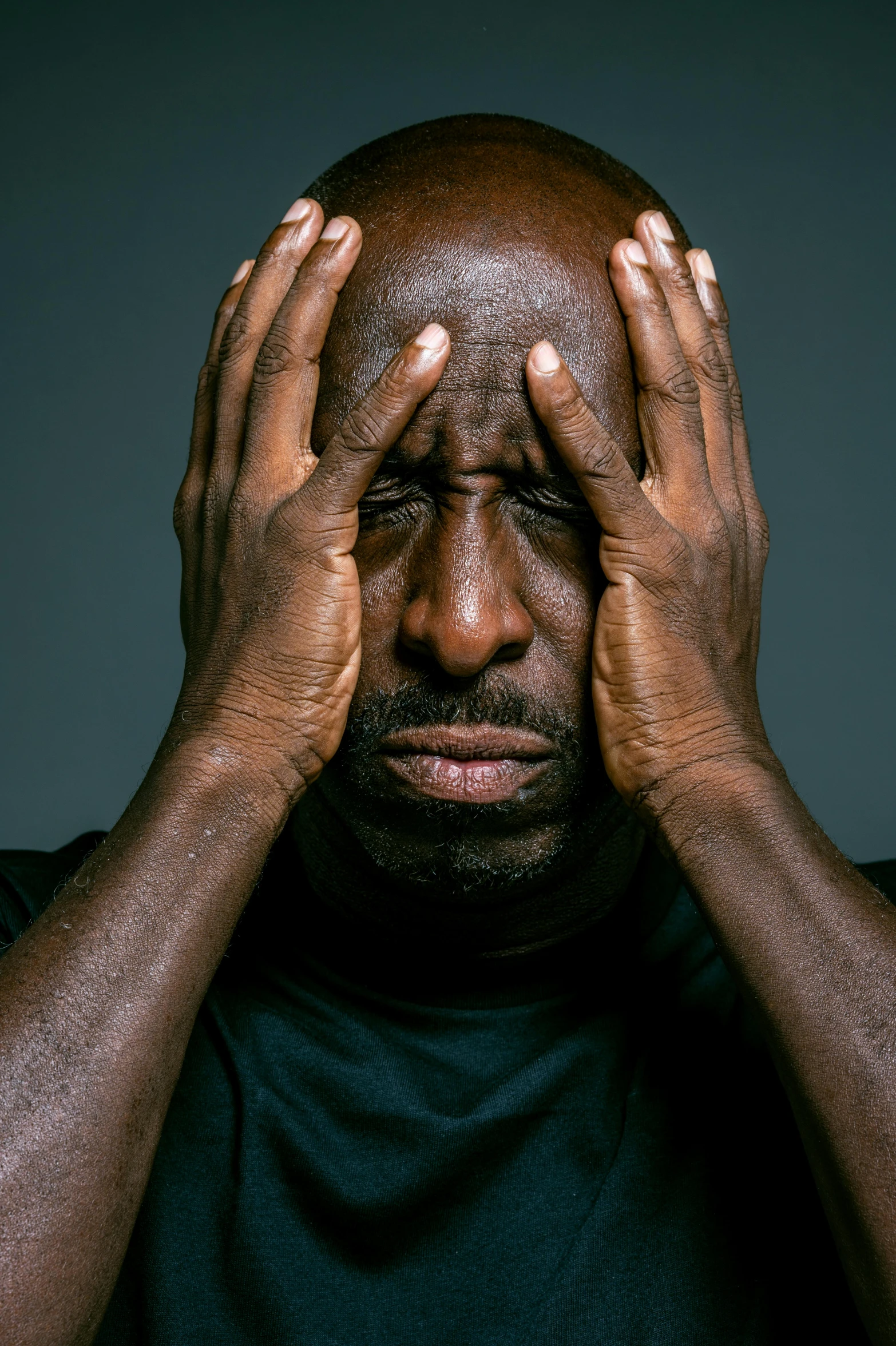 a man covering his face with his hands, by Paul Davis, pexels contest winner, hyperrealism, shaq, stern expression, tony hawk crying, lance reddick