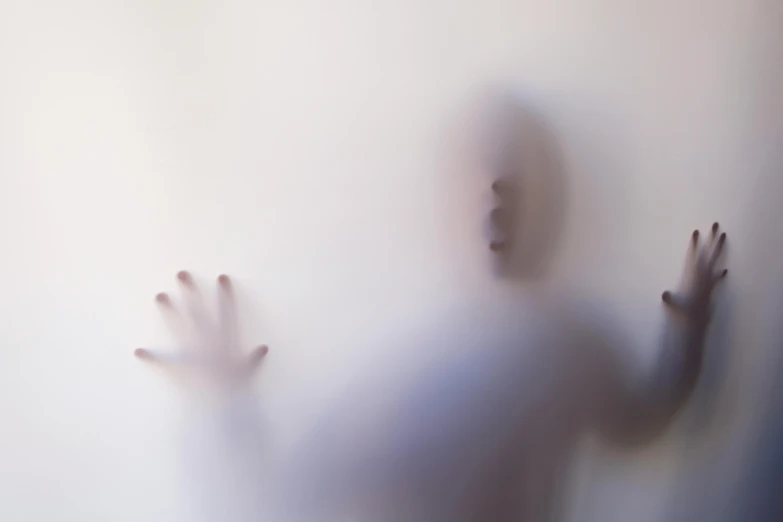 a blurry image of a person with their hands in the air, by Jan Rustem, conceptual art, ghostly mist, white backdrop, shadowed face, ignant