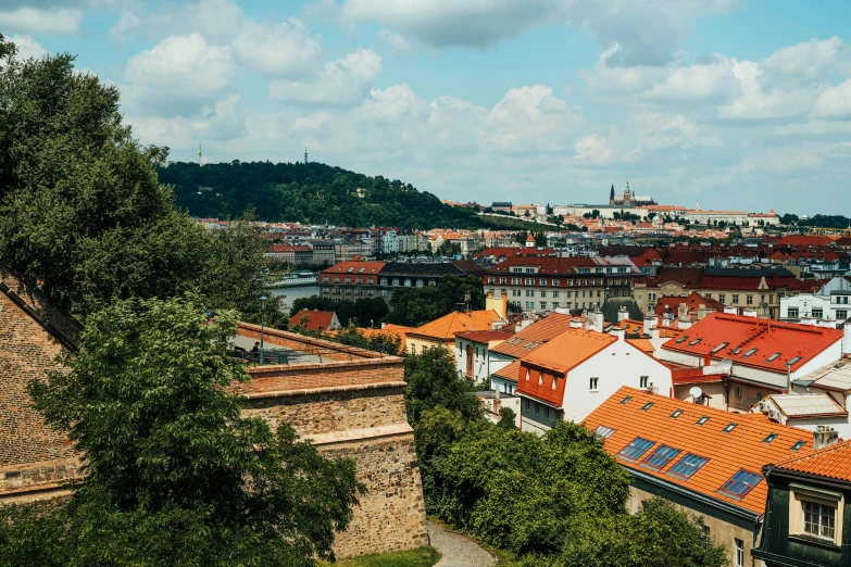 a view of a city from the top of a hill, by Tobias Stimmer, pexels contest winner, renaissance, prague in the background, vibrant foliage, 2000s photo, slide show