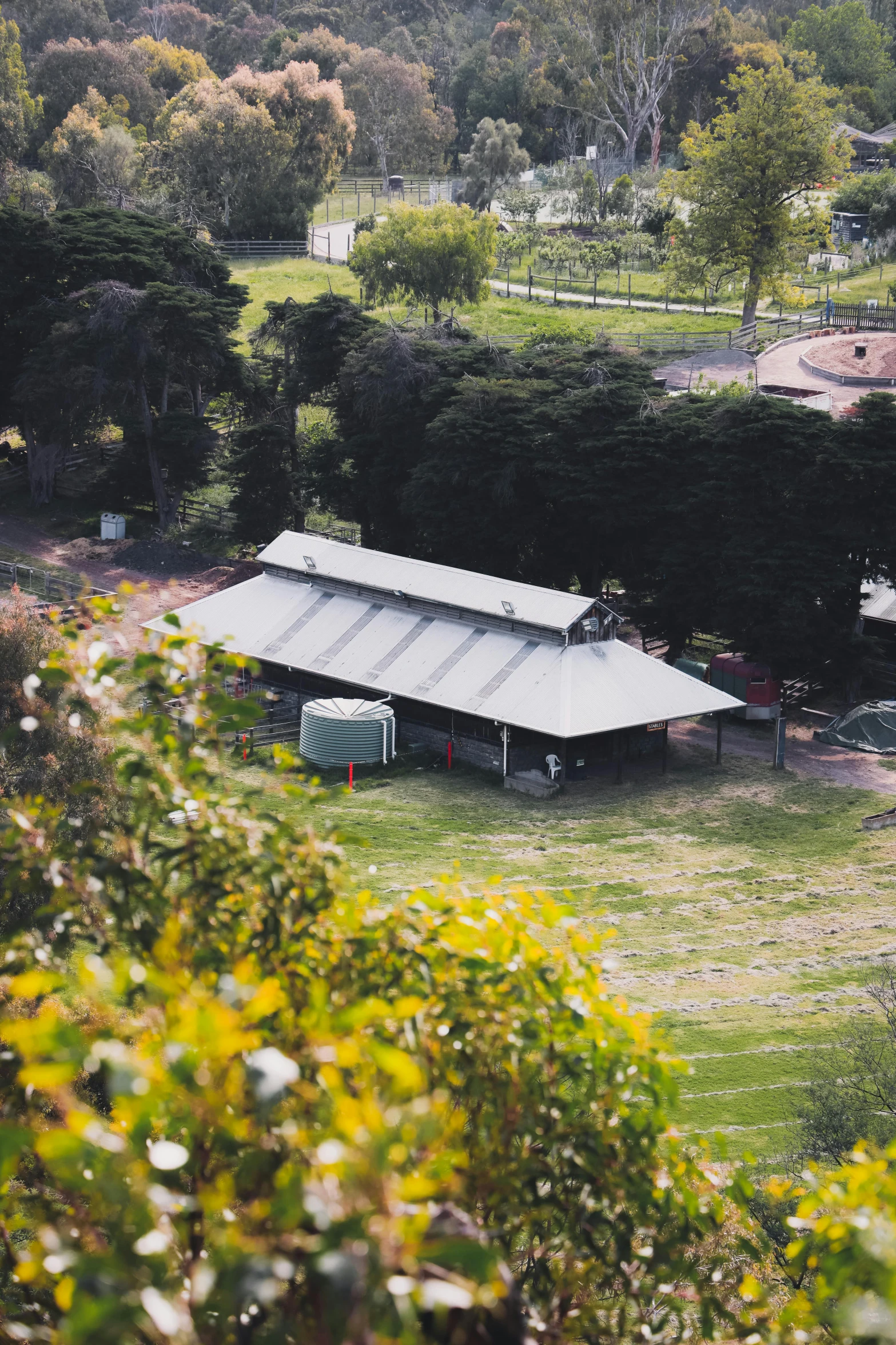 a train traveling through a lush green countryside, a tilt shift photo, happening, of augean stables, covered outdoor stage, melbourne, built on a steep hill