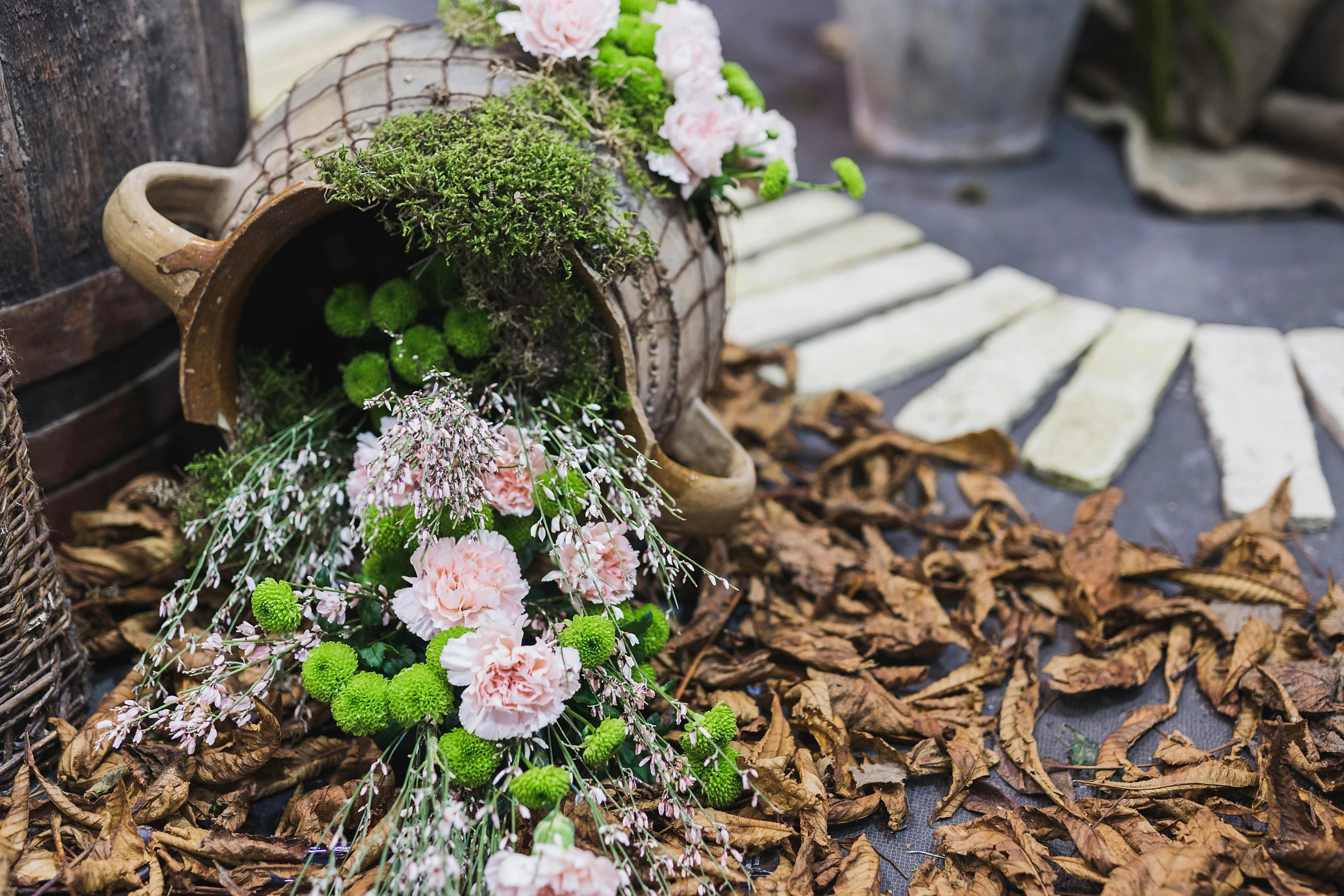 a bunch of flowers sitting on top of a pile of leaves, wood branch moss plants, cornucopia, floral couture, exterior shot