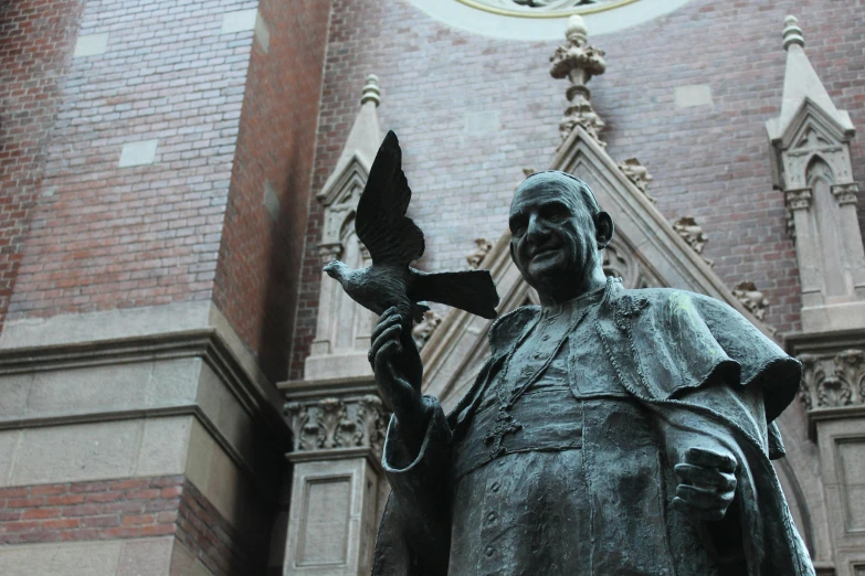 a statue of a man holding a bird in front of a building, a statue, inspired by Thomas Aquinas Daly, pexels contest winner, academic art, jacob riis, made of bronze, holy cross, impressive detail : 7