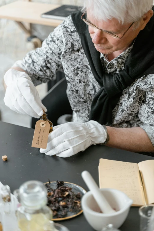 a woman that is sitting at a table, artefact, hand holding a knife, curated collections, brown