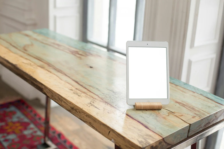 a cell phone sitting on top of a wooden table, inspired by Constantin Hansen, happening, using a magical tablet, light wood, detailed product image, rectangle