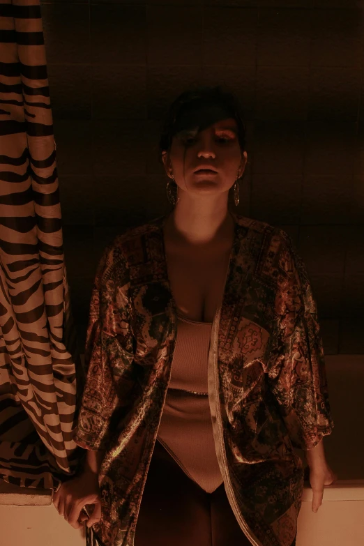 a woman standing in front of a zebra print curtain, an album cover, inspired by Elsa Bleda, renaissance, in kimono, lowkey lighting, ( ( theatrical ) ), concerned