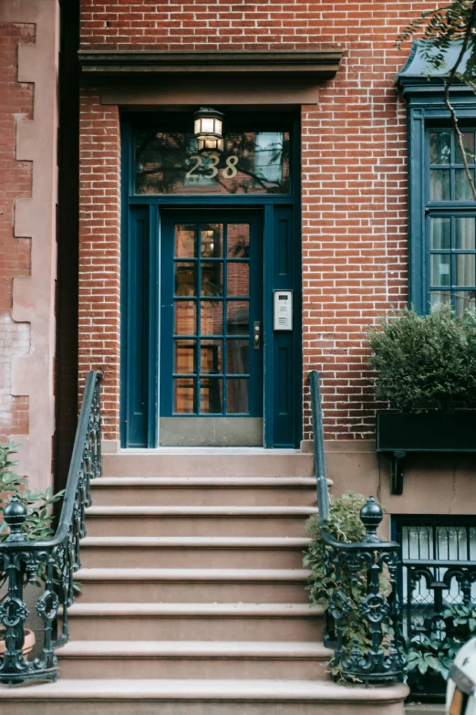 a woman sitting on the steps of a building, a photo, trending on unsplash, arts and crafts movement, french door window, new york back street, slate, seen from outside