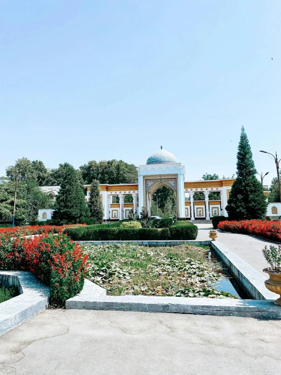 a flower garden in front of a white building, inspired by Abdullah Gërguri, unsplash contest winner, mausoleum, persian design, 💣 💥💣 💥, sangyeob park