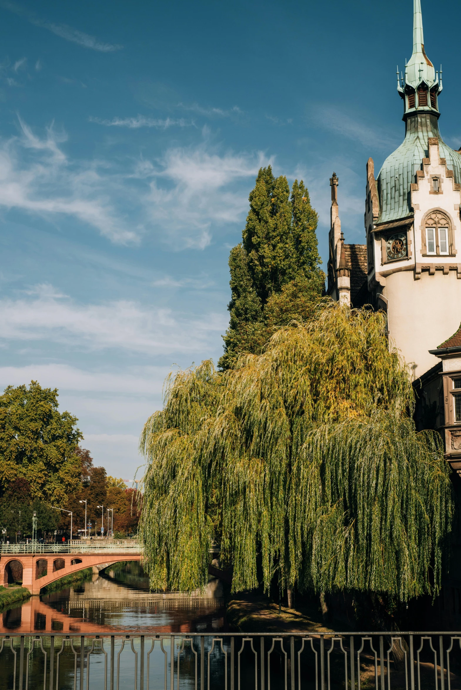 a large building next to a body of water, inspired by Albert Paris Gütersloh, art nouveau, curved trees, hannover, church in the background, best photo