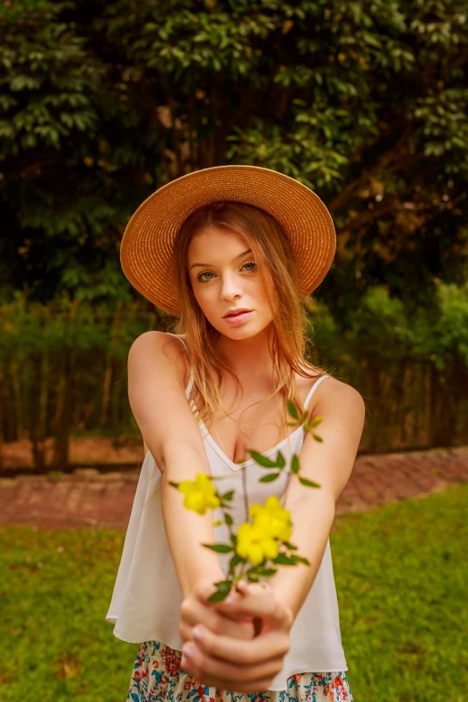 a woman in a hat holding a bunch of flowers, a picture, inspired by Ksenia Milicevic, pexels contest winner, portrait of anya taylor-joy, in sao paulo, lush surroundings, avatar image