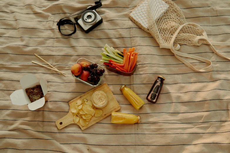 a bunch of food sitting on top of a bed, by Carey Morris, pexels contest winner, picnic, tan, glossy surface, old fashion