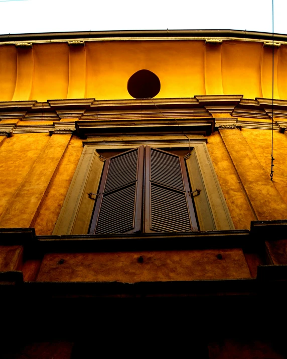 a tall building with a clock on top of it, an album cover, inspired by Michelangelo Buonarotti, unsplash contest winner, yellow hue, open window at night, raw sienna, florence