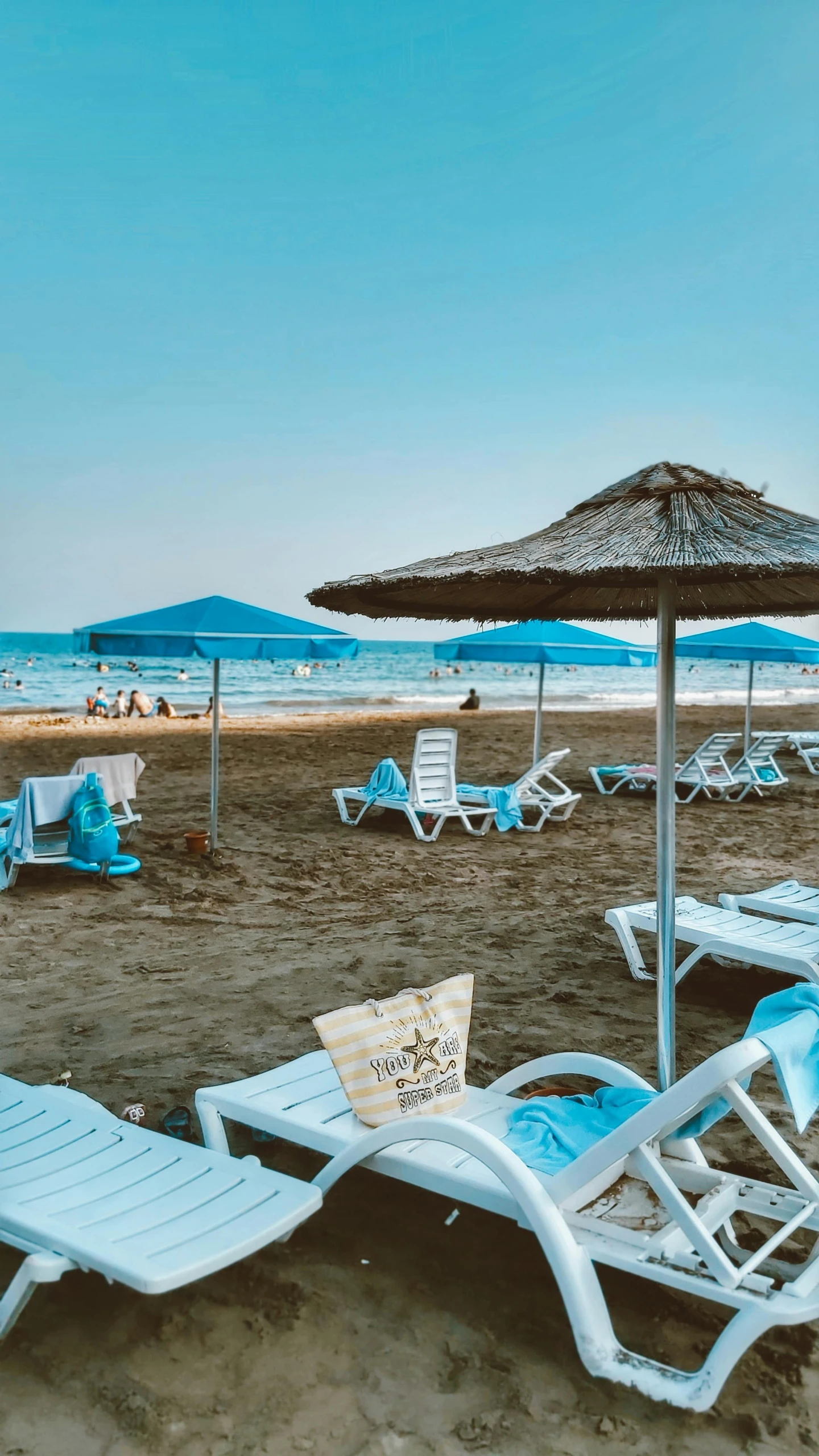 beach chairs and umbrellas on a sandy beach, pexels, plasticien, cyprus, low quality photo, square, panoramic shot