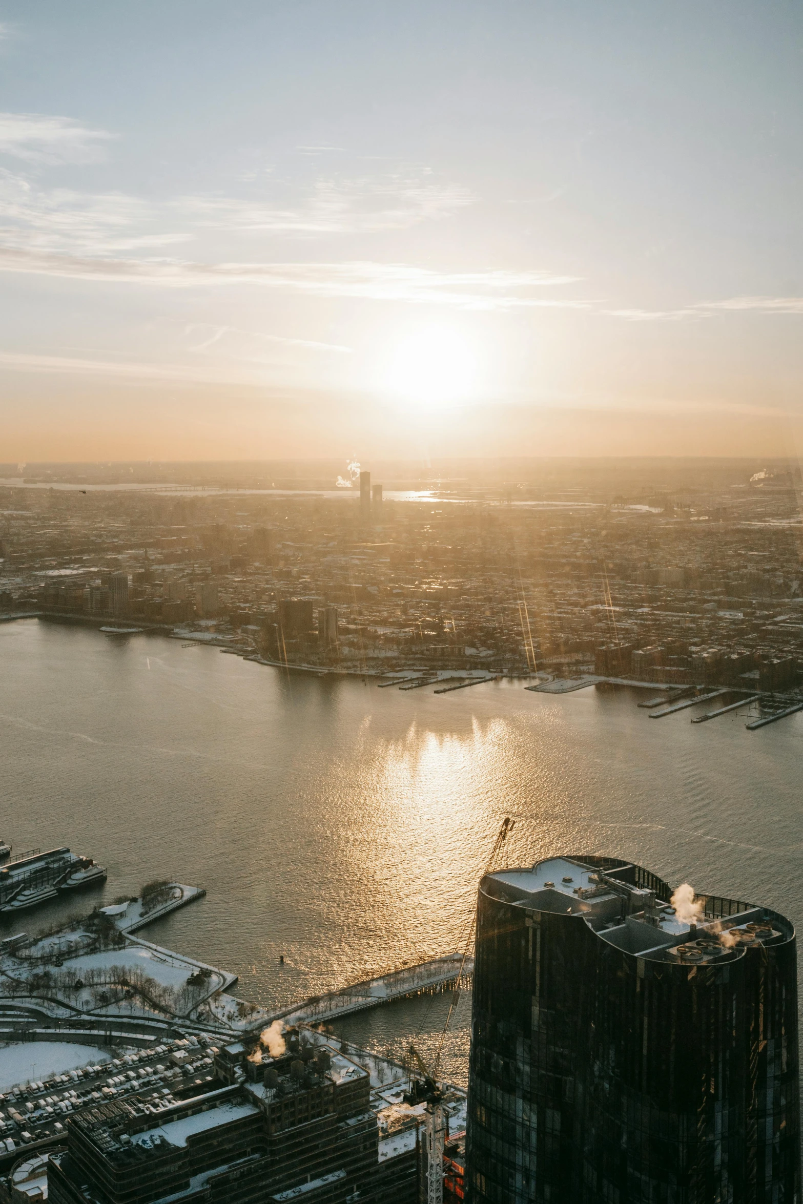 a view of a city from the top of a building, by Jan Tengnagel, pexels contest winner, happening, winter sun, new york harbour, aerial view cinestill 800t 18mm, netherlands