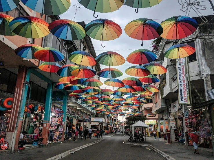 a street filled with lots of colorful umbrellas, a cartoon, pexels contest winner, reunion island, kuala lumpur, canopies, album photo