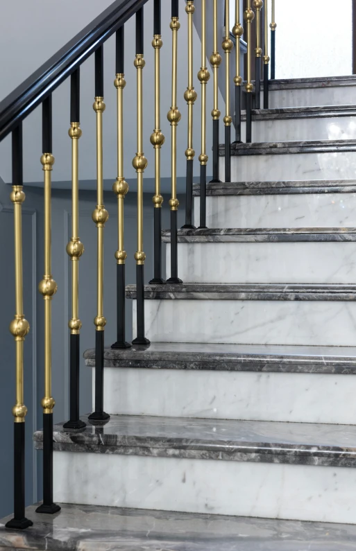 a close up of a set of stairs in a building, by David Simpson, pexels, baroque, ashford black marble, brass, grey, jen atkin