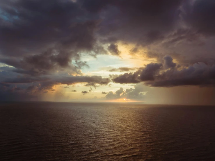 a large body of water under a cloudy sky, a picture, unsplash, romanticism, crepuscular, open ocean, by emmanuel lubezki, instagram photo