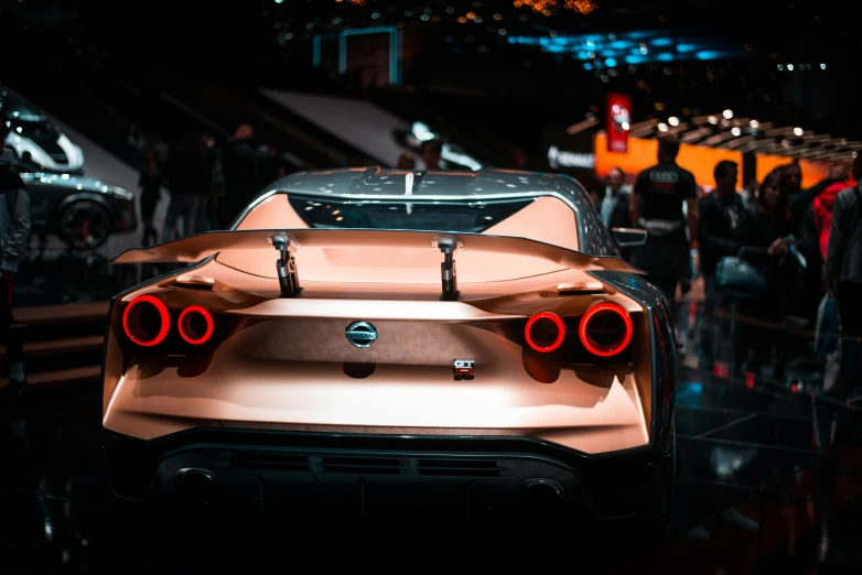 a close up of a car on display at a car show, pexels contest winner, hypermodernism, rear lighting, rose gold, gtr xu1, octane render - n 9