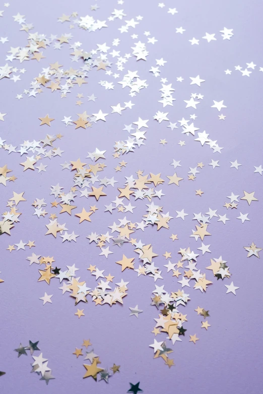 a bunch of gold and silver stars on a purple background, by Julia Pishtar, trending on unsplash, confetti, on a pale background, ((purple)), natural starlight