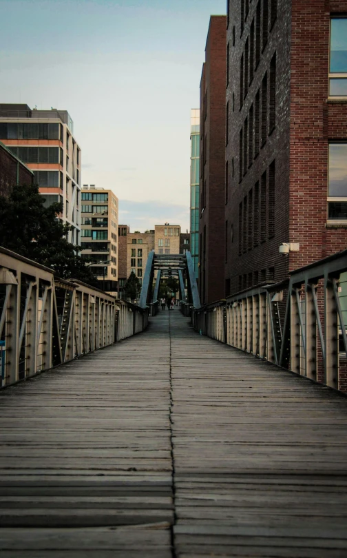 a long wooden bridge over a city street, inspired by Thomas Struth, unsplash, montreal, high quality photo, medium format, fire escapes