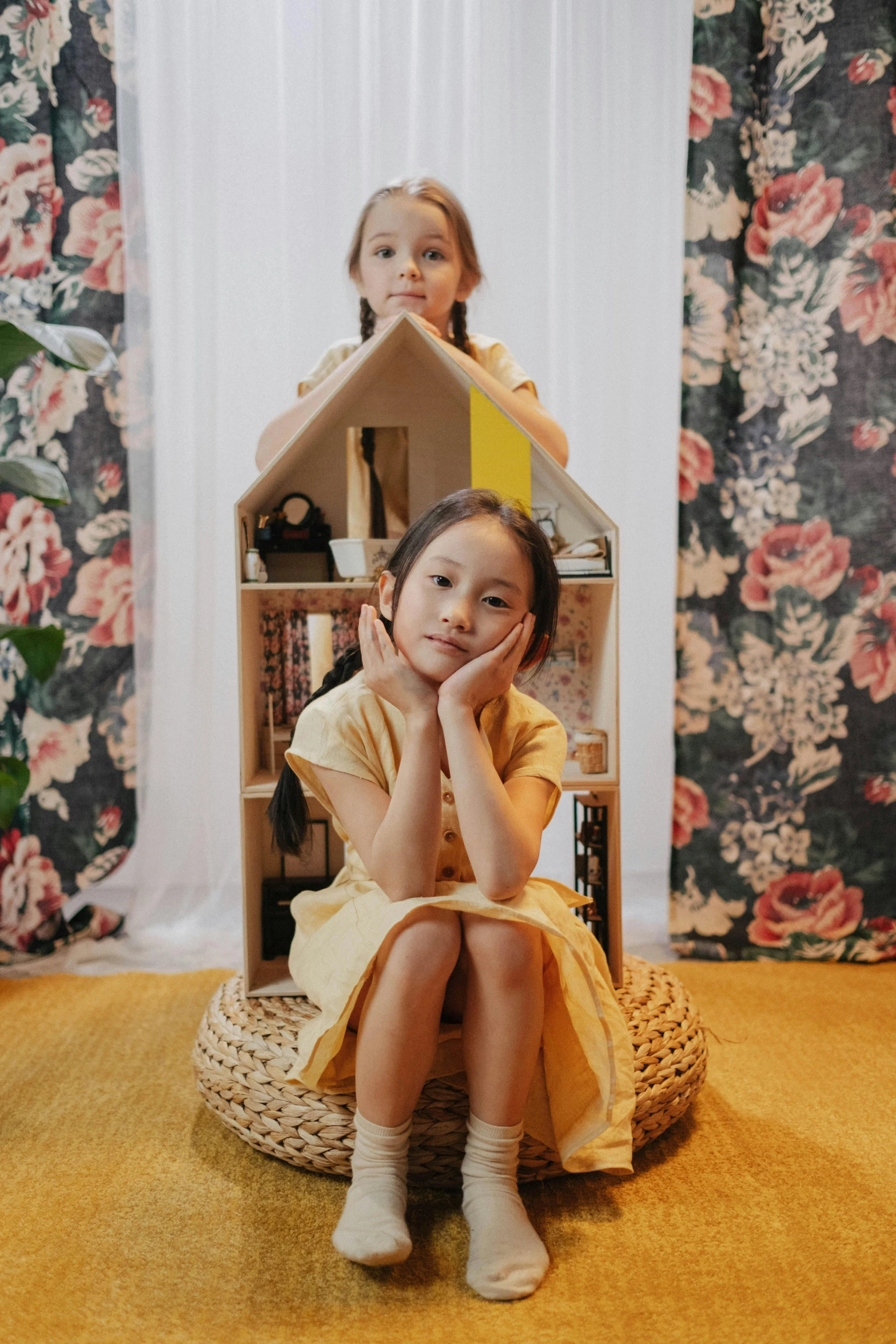 two little girls sitting in front of a doll house, by Juliette Leong, pexels contest winner, lady using yellow dress, made of cardboard, lookbook, ren heng