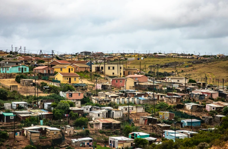 a group of houses sitting on top of a hill, xenophobia, vibrant but dreary, whealan, taken in 2 0 2 0