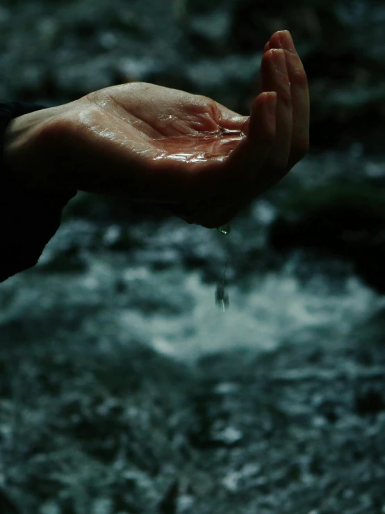 a person that is holding something in their hand, inspired by Elsa Bleda, pexels contest winner, renaissance, stream of water, album art, dark, environments )