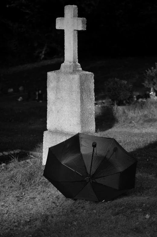 a black and white photo of a cross and an umbrella, a black and white photo, by Felix-Kelly, tombs, max dennison, dark. no text, parasol