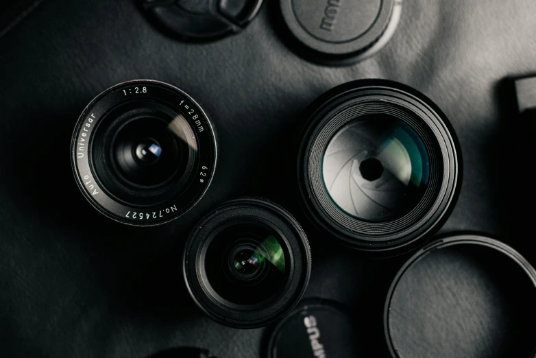 a bunch of cameras sitting on top of a table, pexels contest winner, photorealism, macro camera lens, flatlay, 1. 2 aperture, looking up at camera