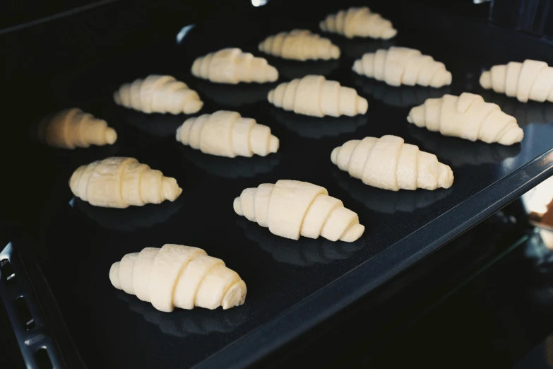 freshly baked croissants sit in an oven, inspired by Richmond Barthé, unsplash, process art, mary jane ansell, carved ivory, resin coated, thumbnail