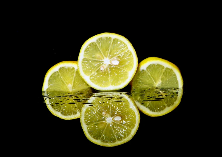 a group of lemons sitting on top of a reflective surface, a picture, pixabay, full of greenish liquid, avatar image