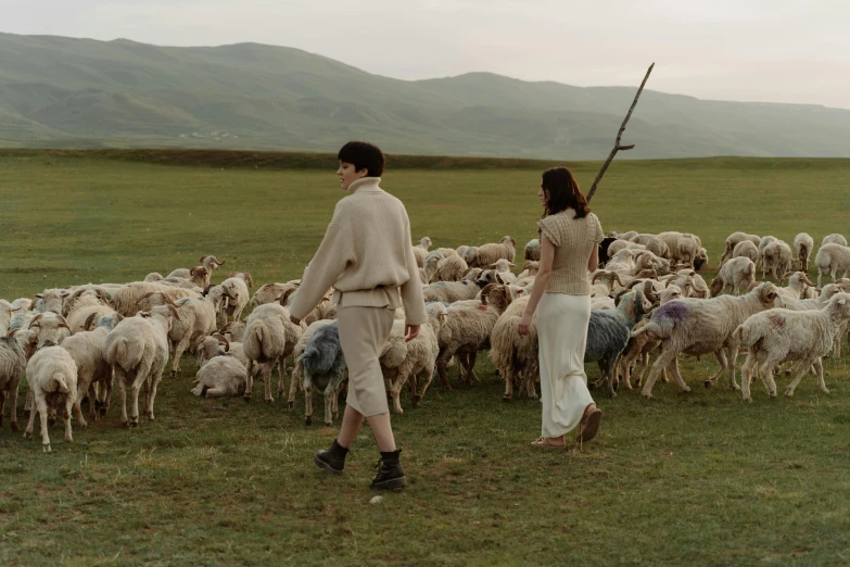 a man and a woman standing in front of a herd of sheep, an album cover, by Alexander Runciman, pexels contest winner, renaissance, ayanamikodon and irakli nadar, movie still frame, pastoral, donglu yu