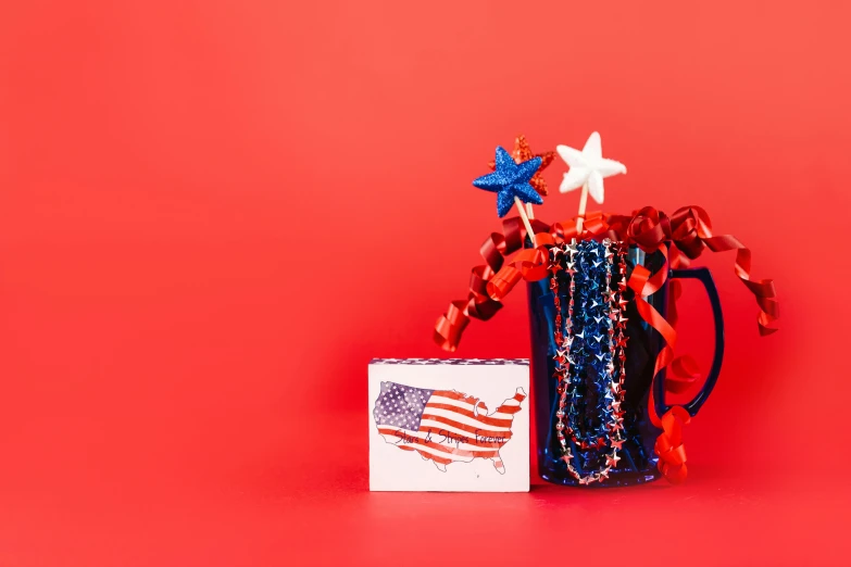 a vase filled with red, white and blue stars, by Julia Pishtar, shutterstock contest winner, greeting card, state of the union, drink, presents