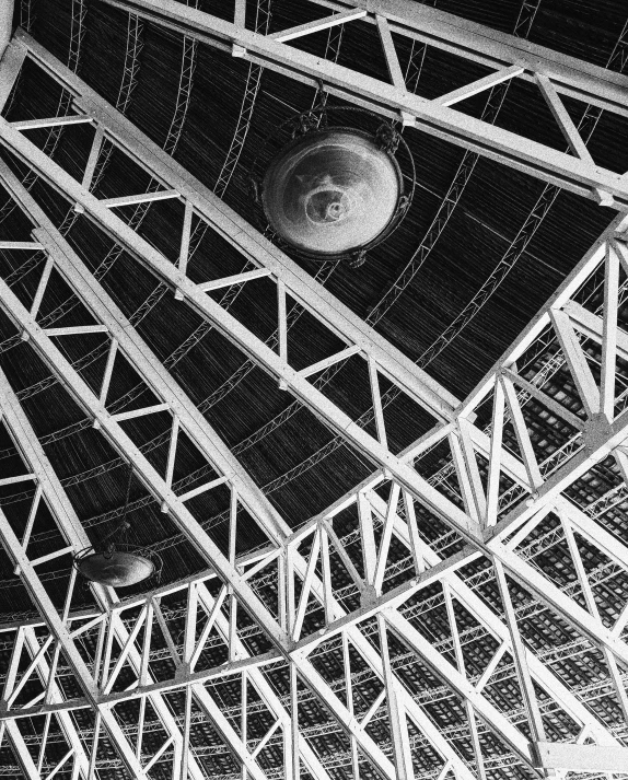 a black and white photo of a clock in a building, inspired by Alexander Rodchenko, unsplash, light and space, flying saucer, red trusses, interior of a star destroyer, taken in zoo