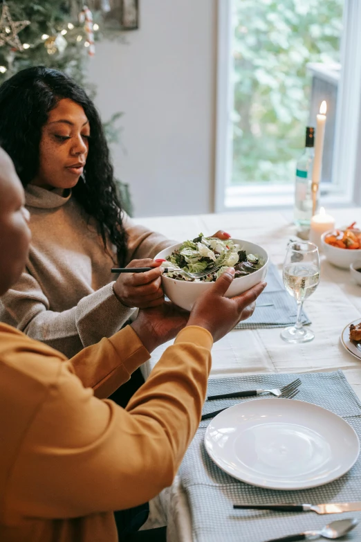 a group of people sitting around a dinner table, bowl filled with food, couple, profile image, african american woman