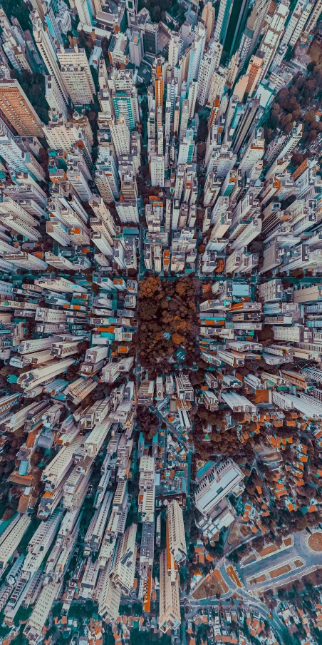 an aerial view of a city with tall buildings, inspired by Beeple, unsplash contest winner, an overpopulated, 3/4 view from below, zoomed out shot, photo 8 k