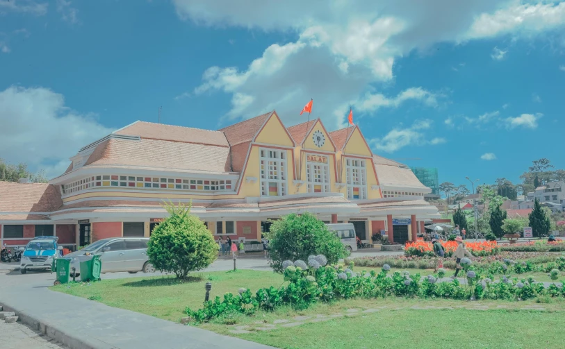 a large building sitting on top of a lush green field, a colorized photo, pexels contest winner, train station background, vietnam, background image, square