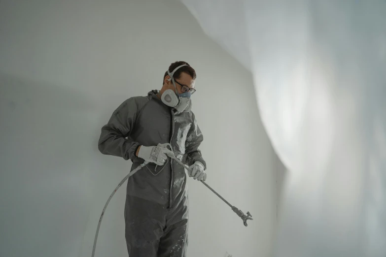 a man standing on top of a snow covered slope, an airbrush painting, arbeitsrat für kunst, dust mask, high-quality photo, white room, plating