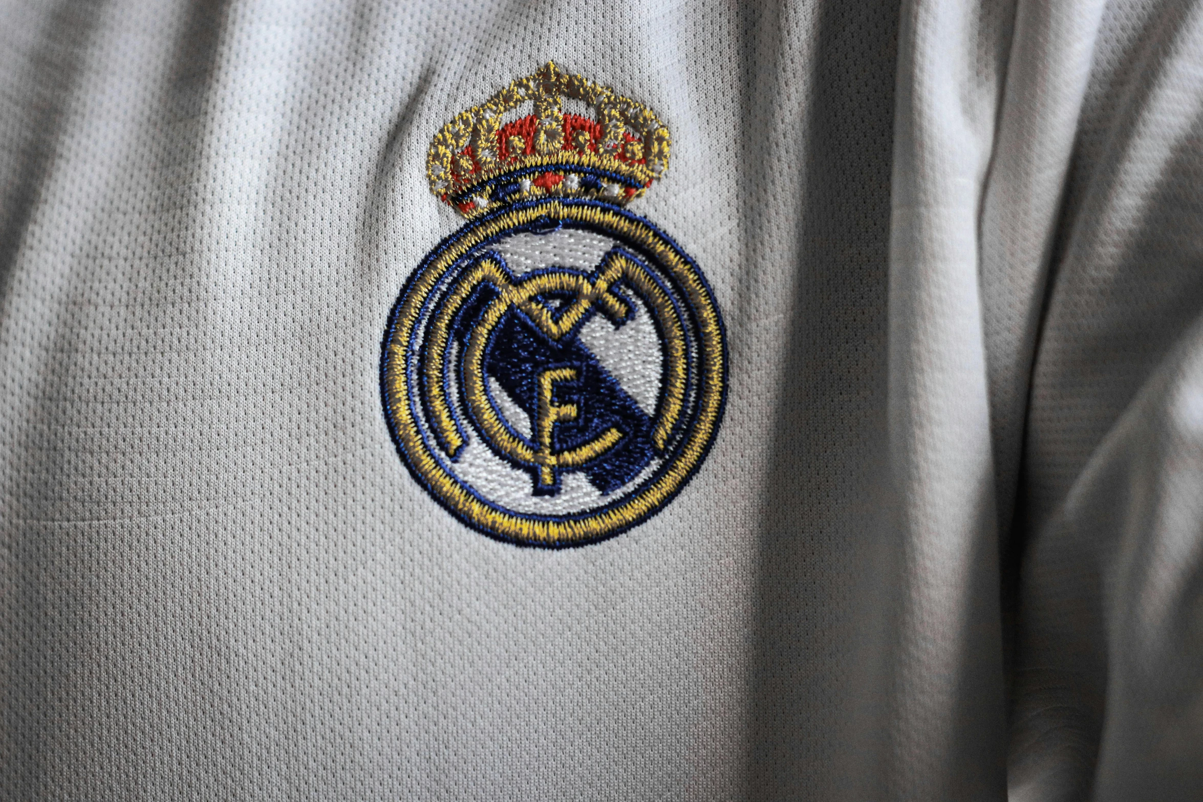 a close up of a shirt with a badge on it, realism, madrid, official media, royal robe, white