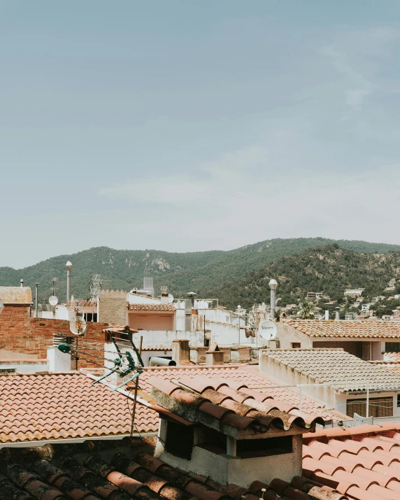 a view of a city from the roof of a building, inspired by Modest Urgell, trending on unsplash, above a village, slightly tanned, the city of santa barbara, low quality photo