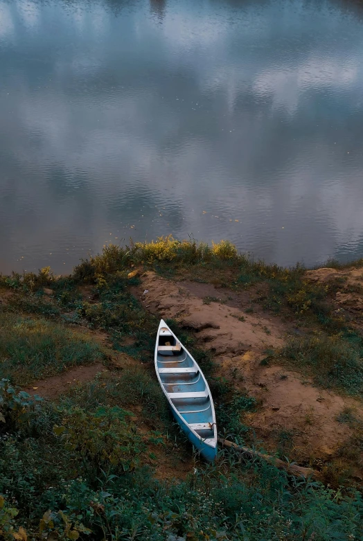 a boat is sitting on the shore of a lake, by Adam Marczyński, pexels contest winner, valley mist, minn, small canoes, fine art print