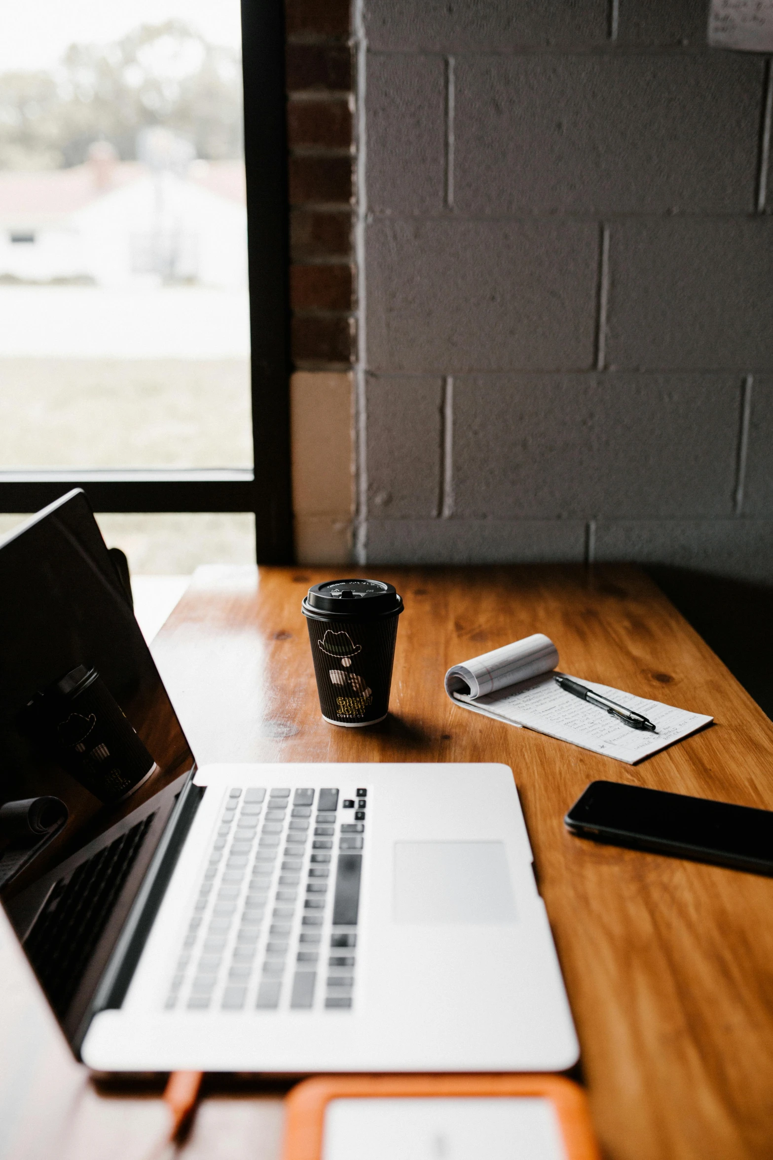 a laptop computer sitting on top of a wooden desk, trending on pexels, table in front with a cup, low quality photo, 1 2 9 7