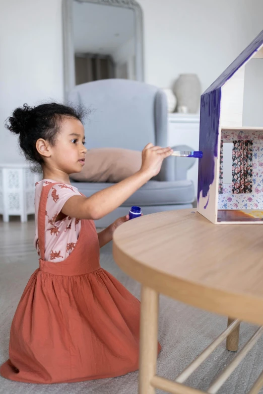 a little girl is playing with a doll house, by Arabella Rankin, visual art, holding a paintbrush, indigo, te pae, art set