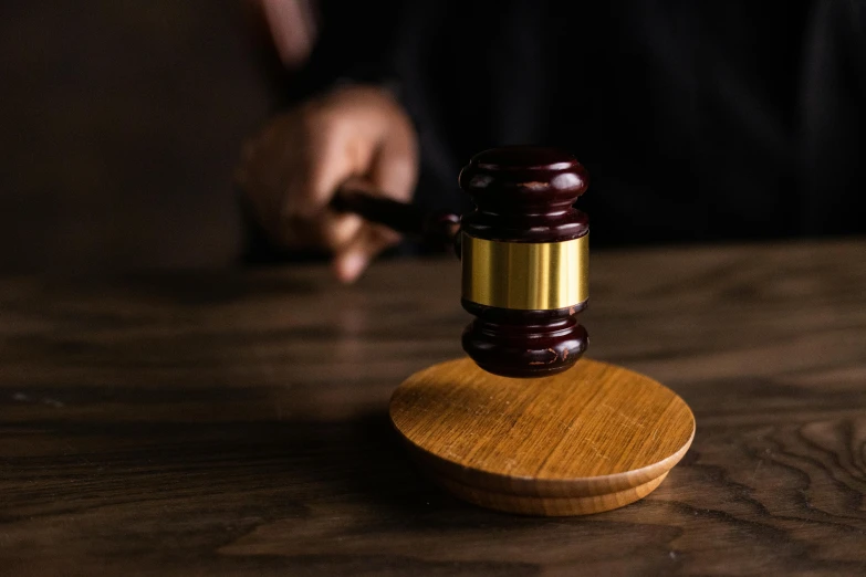 a judge's gavel sitting on top of a wooden table, unsplash, figuration libre, multiple stories, a person standing in front of a, illegal, background image