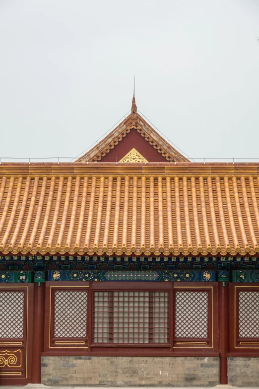 a man sitting on a bench in front of a building, inspired by Zhang Zeduan, trending on unsplash, cloisonnism, intricate detailed roof, overcast weather, square, detail shot