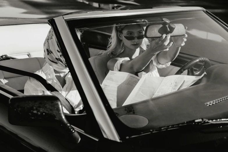 a black and white photo of two women in a car, by Patrick Pietropoli, photorealism, reading a newspaper, nina agdal, full of mirrors, lamborghini countach