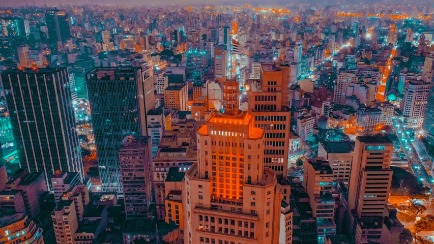 an aerial view of a city at night, a colorized photo, by Luis Miranda, pexels contest winner, são paulo, orange and cyan lighting, instagram post, tall buildings on the sides